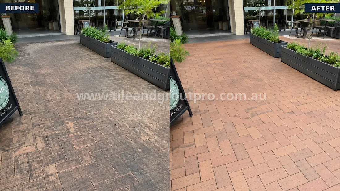 Before tile renewal, clay brick pavers outside a café seating area showed heavy foot-traffic wear, dark surface grime, weather staining, and faded colour in a commercial outdoor setting.