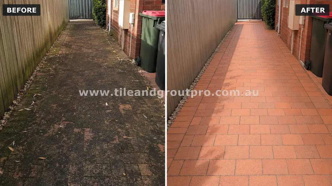 Before tile renewal, clay brick pavers in a residential side access pathway showed heavy black staining, moss growth, organic buildup, and weathering between a timber fence and brick home.