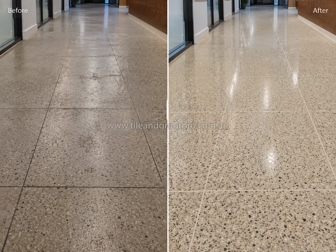 Before tile renewal, the commercial terrazzo hallway floor appeared dull and lightly stained with reduced shine and visible foot traffic wear in an office corridor.