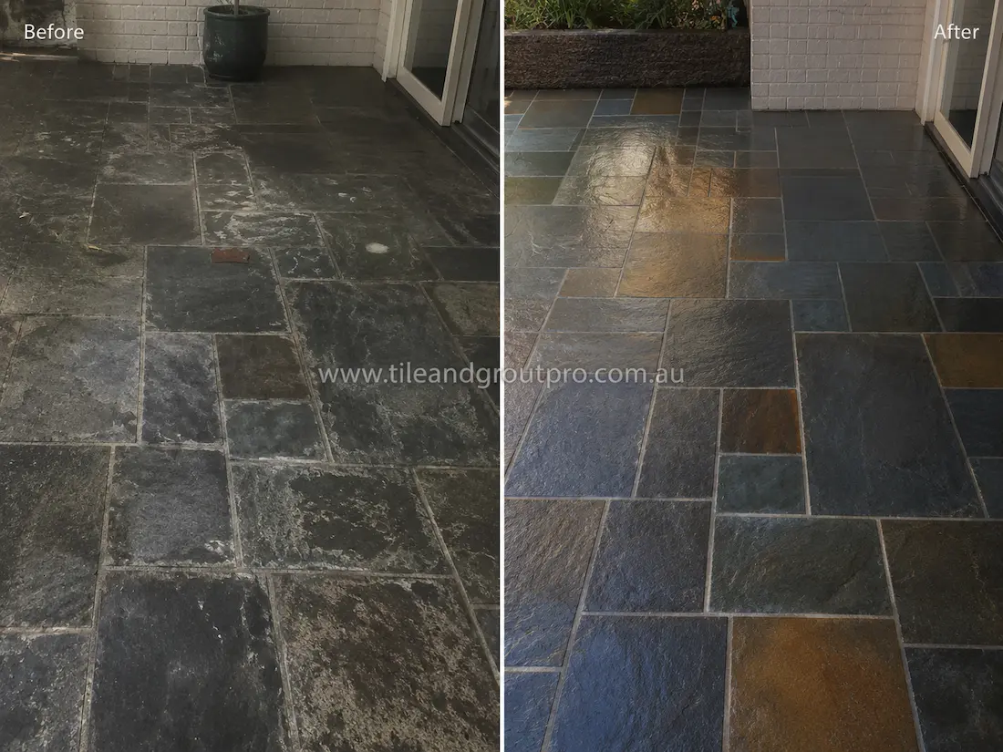 Before tile renewal, the outdoor slate patio tiles showed dirt buildup, faded colouring, and weathered surfaces in a residential courtyard area.