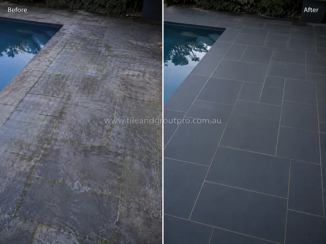 Before tile renewal, the outdoor poolside stone pavers showed weathering, surface residue, and moss buildup around grout joints near the swimming pool area.