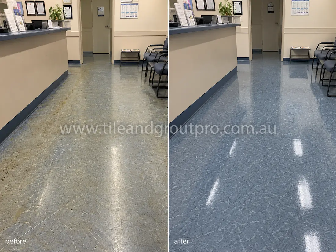 Medical clinic waiting room with blue linoleum floors before sealer stripping, showing scratches, dull traffic lanes, worn finish, and discolored sealer near the reception desk and seating area.