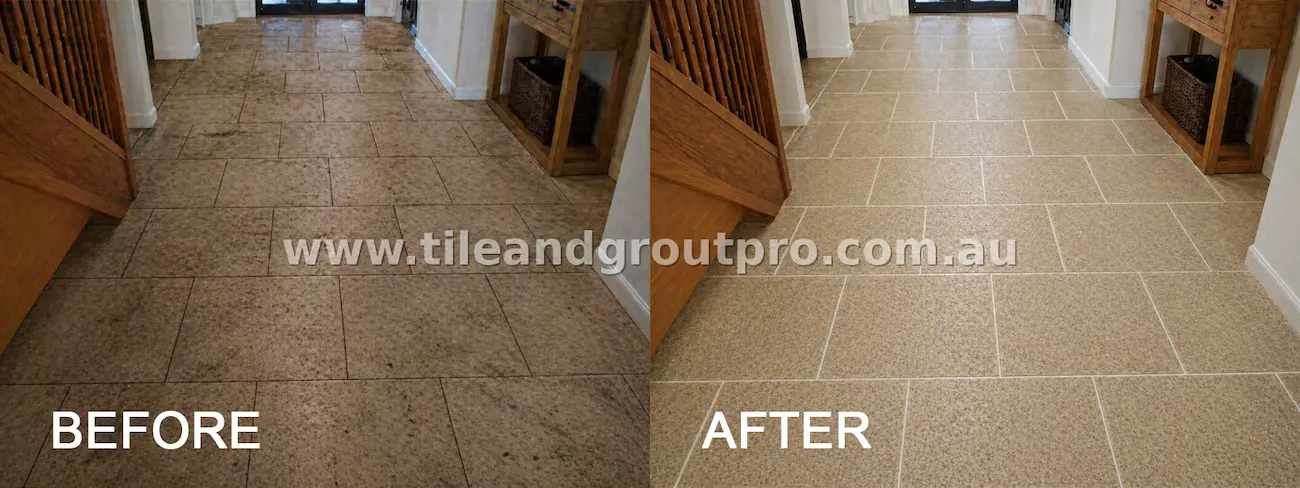 Indoor natural stone hallway floor tiles with embedded dirt, traffic wear, and discoloured grout lines before tile and grout cleaning