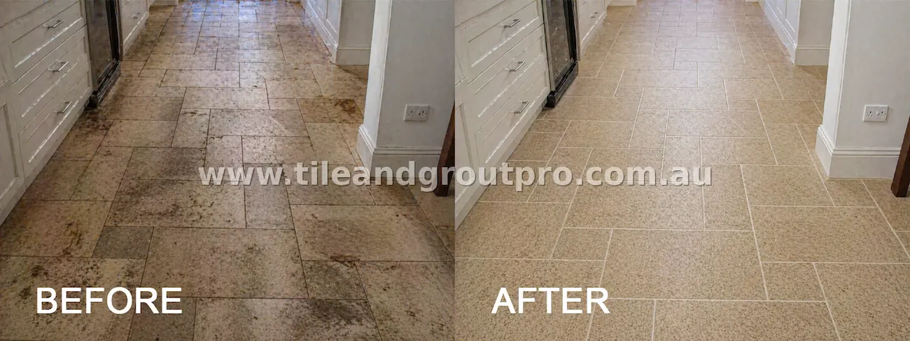 Natural stone kitchen floor tiles with heavy staining, grease buildup, and dark grout discoloration before deep tile and grout cleaning