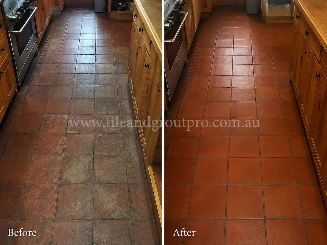 Residential kitchen with dark red quarry floor tiles showing uneven sealer wear, discoloration, and dull finish before Sealer Stripping treatment.