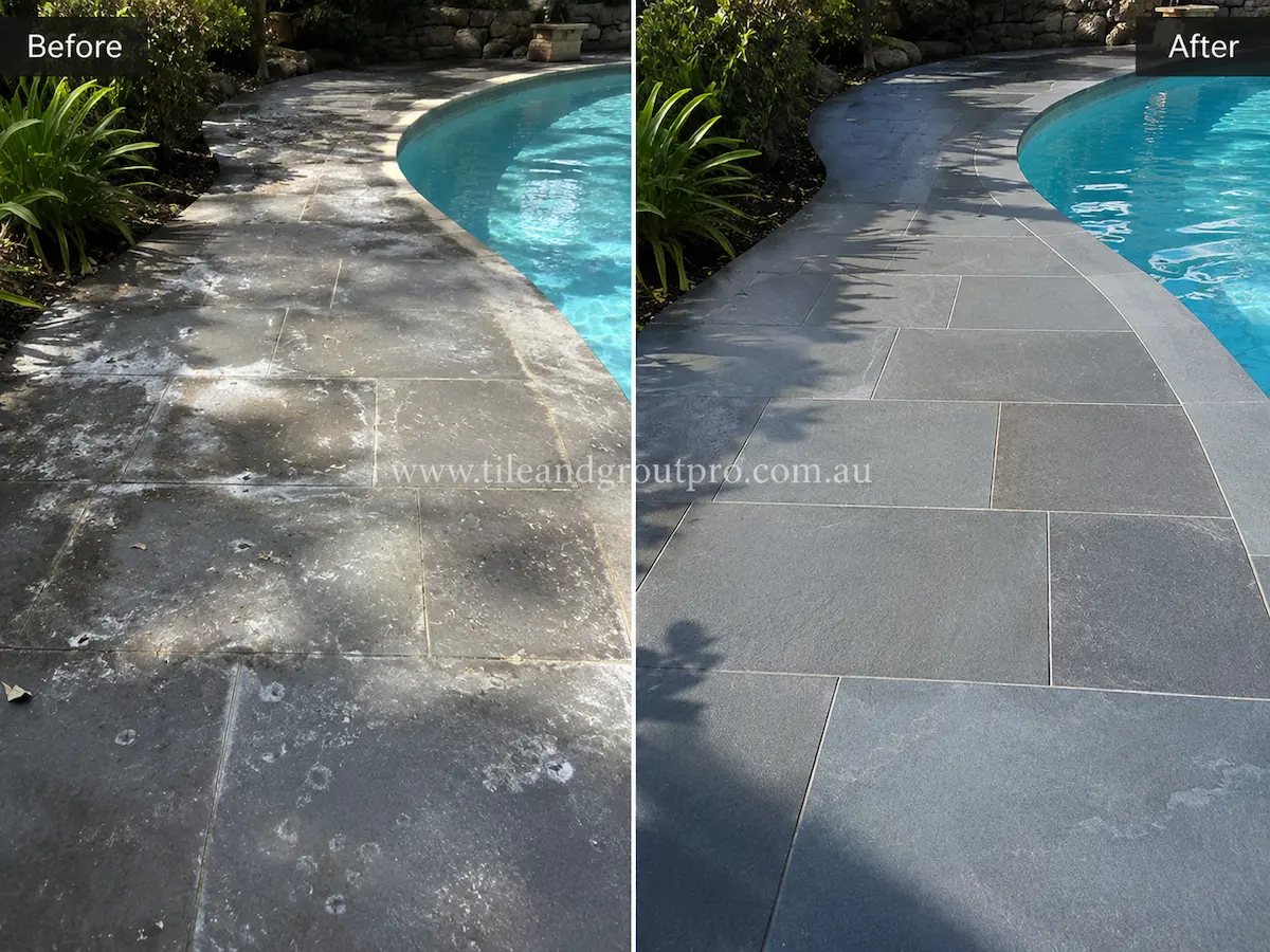 Residential front entrance bluestone pathway before sealer stripping showing worn grey stone tiles with patchy residue leading to front steps between trimmed hedges.