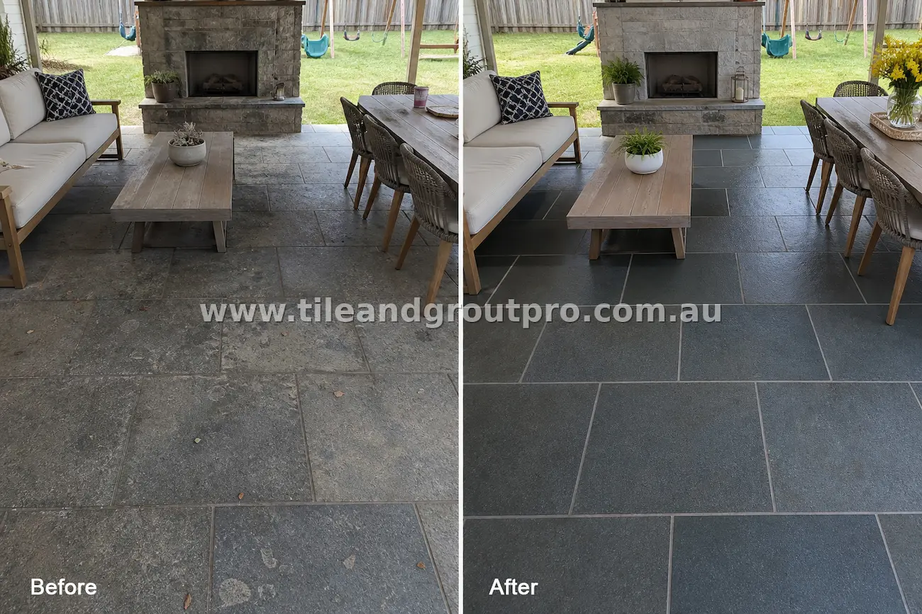Bluestone natural stone tiles on a covered outdoor patio with fireplace showing heavy dirt buildup, weather staining, and dull surface before tile and grout cleaning