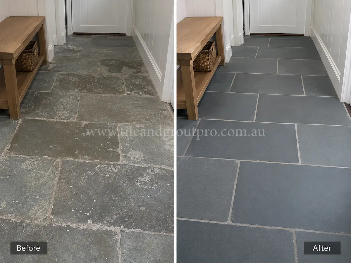 Covered outdoor verandah with bluestone paving before sealer stripping, showing faded grey stone tiles with patchy sealer residue beside brick walls and garden edging.