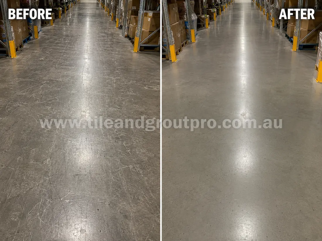 Warehouse concrete floor aisle with visible forklift scratches, abrasion marks, and worn traffic areas before industrial scratch removal service.