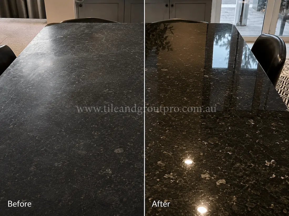 Black granite dining table surface in a dining room showing visible scratches, dull finish, and light etching before professional stone resurfacing and polishing.