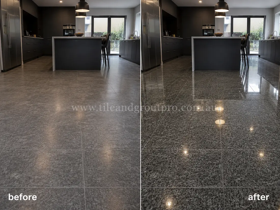 Before stone polishing, the charcoal granite kitchen floor tiles had a matte, worn appearance with minimal shine in a modern kitchen with black cabinetry and pendant lighting.
