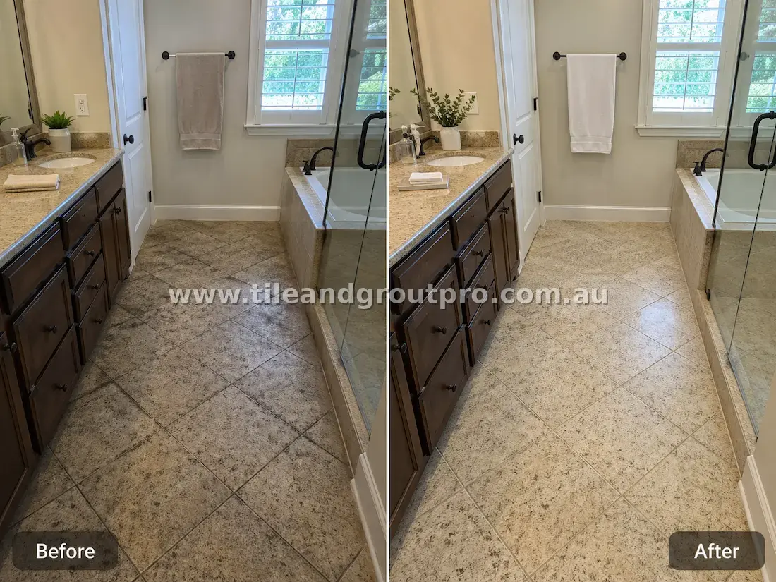 Granite stone bathroom floor tiles with soap residue, grime buildup, and discolored grout near shower and vanity before tile and grout cleaning