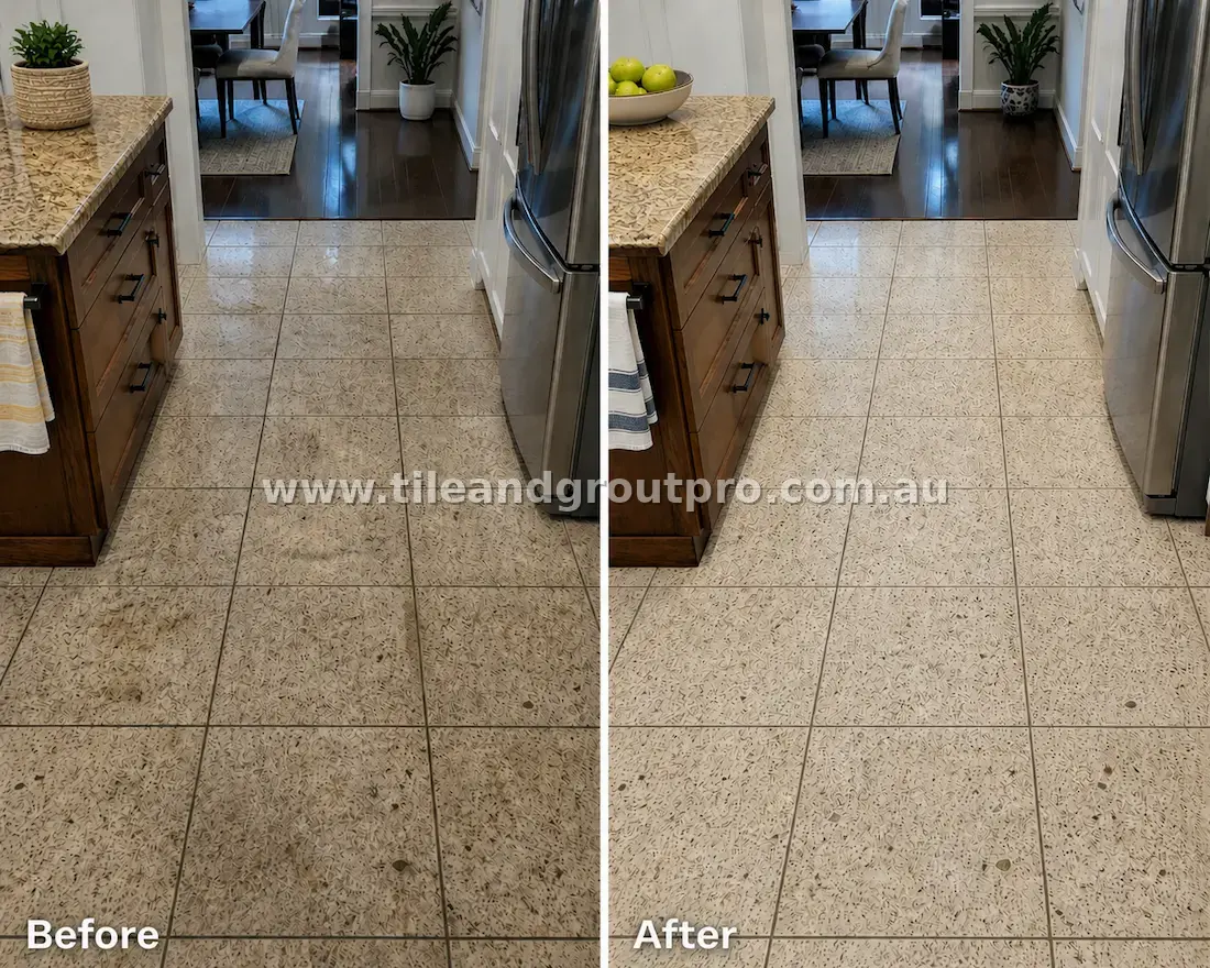Granite stone kitchen floor tiles with visible grime, stains, and discolored grout between cabinets and appliances before professional tile and grout cleaning