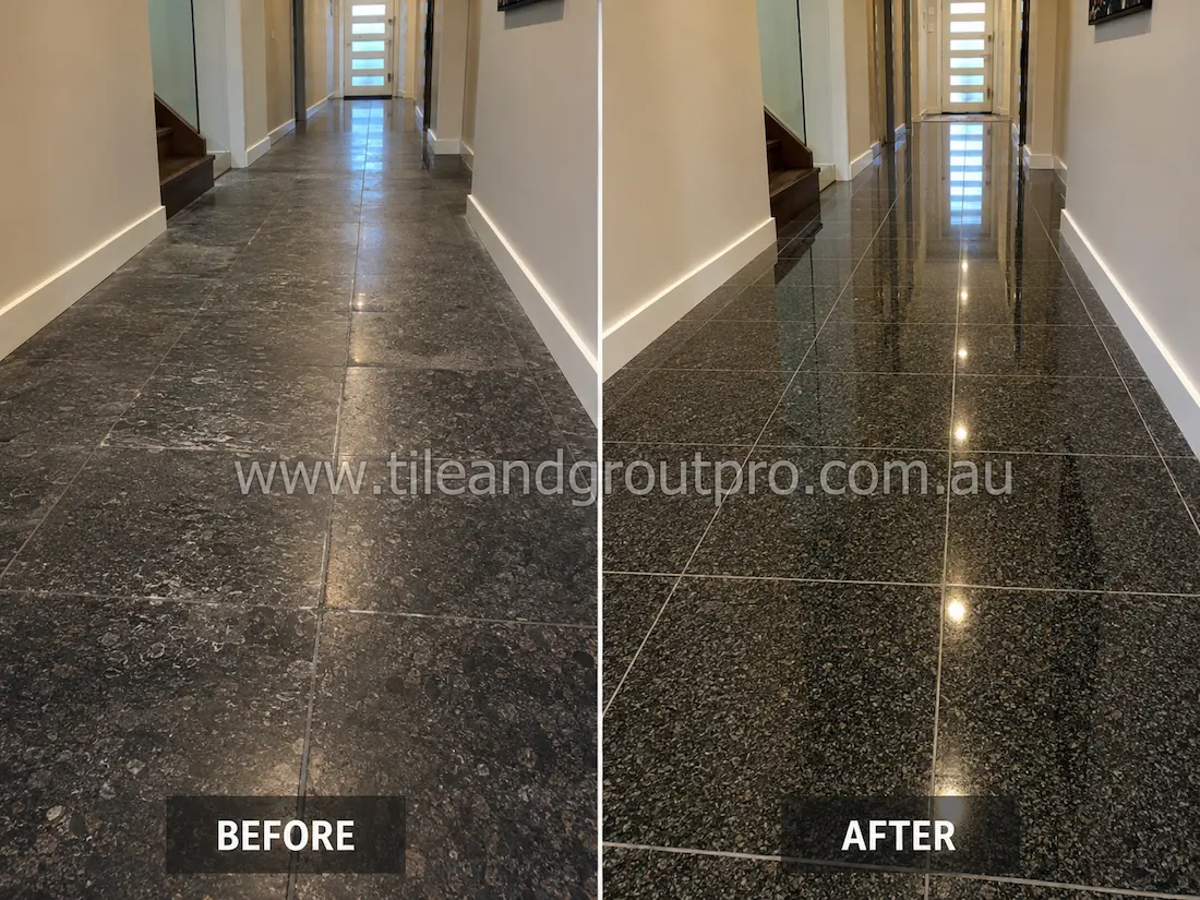 Residential hallway black granite floor before grinding, showing dull stone tiles, light scratches, haze, and uneven reflection along the corridor.