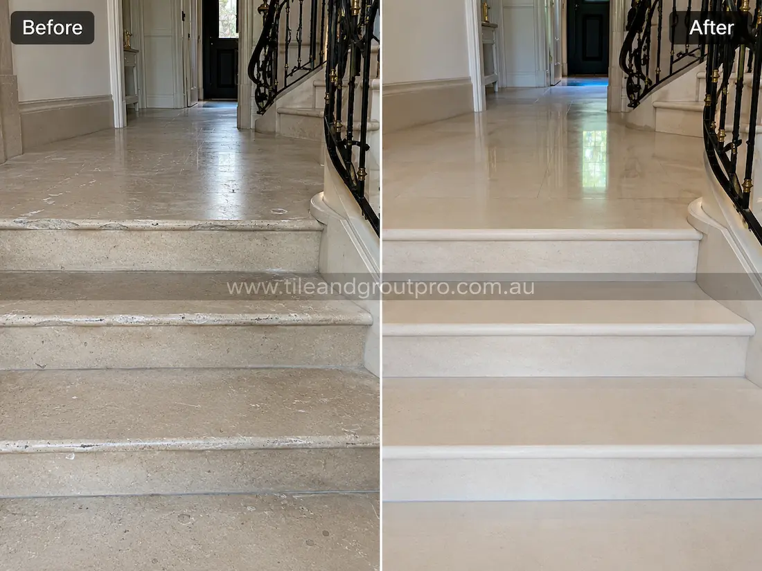Cream limestone staircase and foyer floor with visible etching, scuff marks, and loss of shine before tile resurfacing and polishing.