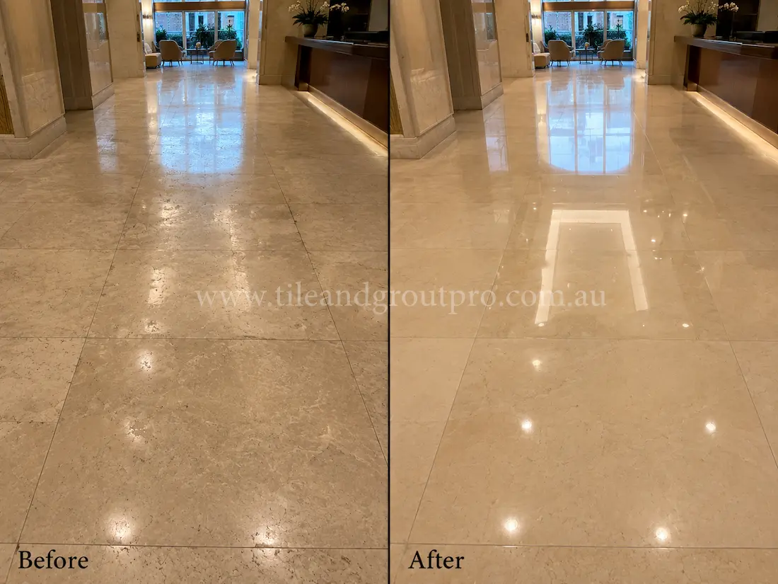Before tile renewal, the commercial marble lobby floor showed dull traffic wear, cloudy reflections, and light surface etching in a hotel reception area.