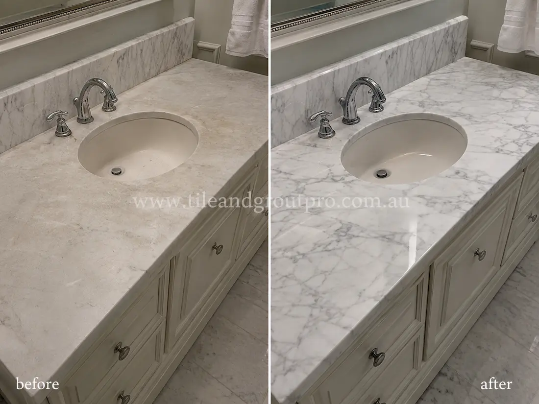 Bathroom marble vanity countertop with a sink basin, showing etching, dullness, and surface staining before tile resurfacing and restoration.