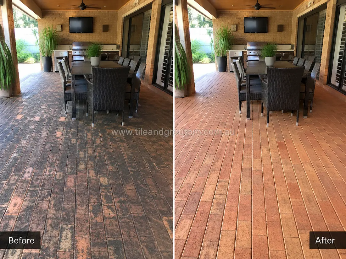 Covered outdoor entertainment area with narrow brick pavers before sealer stripping, displaying heavy sealer deterioration, darkened patches, and uneven surface colour around the dining space.