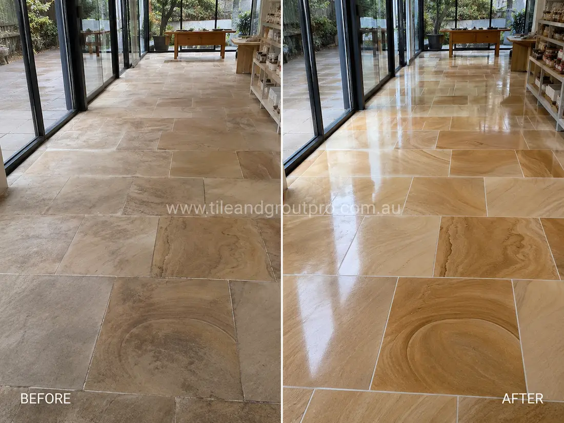 Before stone-polishing of sandstone floor tiles in an indoor entertainment area with cloudy finish, uneven colour tones, and minimal shine.