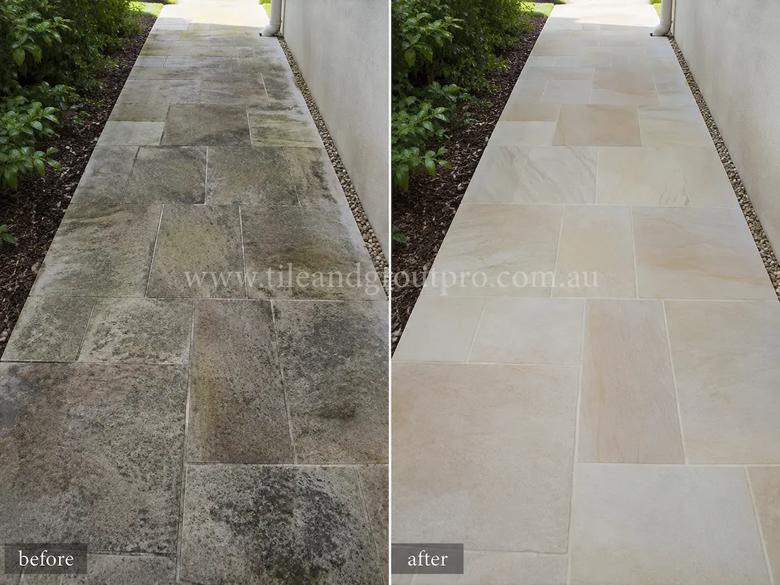 Residential sandstone garden walkway with surface staining, algae growth, and weathering before sandstone tile resurfacing and restoration.