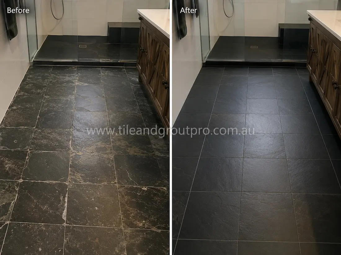 Before and after black slate tile grinding in a bathroom with faded marked natural stone flooring restored to a smooth even matte finish near a walk-in shower.