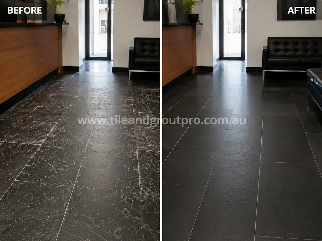 Black slate commercial lobby floor tiles with heavy scratch marks and surface wear before scratch removal and floor restoration service.