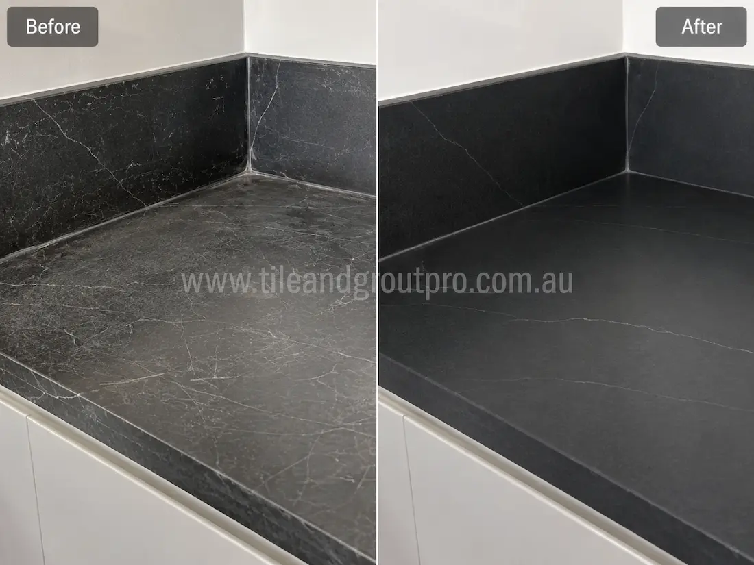Black soapstone bathroom counter with visible scratches and etched marks before professional scratch removal treatment.