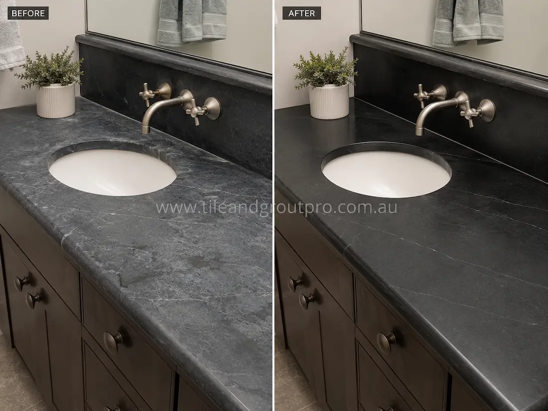Before stone-polishing, the soapstone bathroom vanity countertop around the sink appeared faded with surface marks and reduced sheen in a contemporary bathroom.