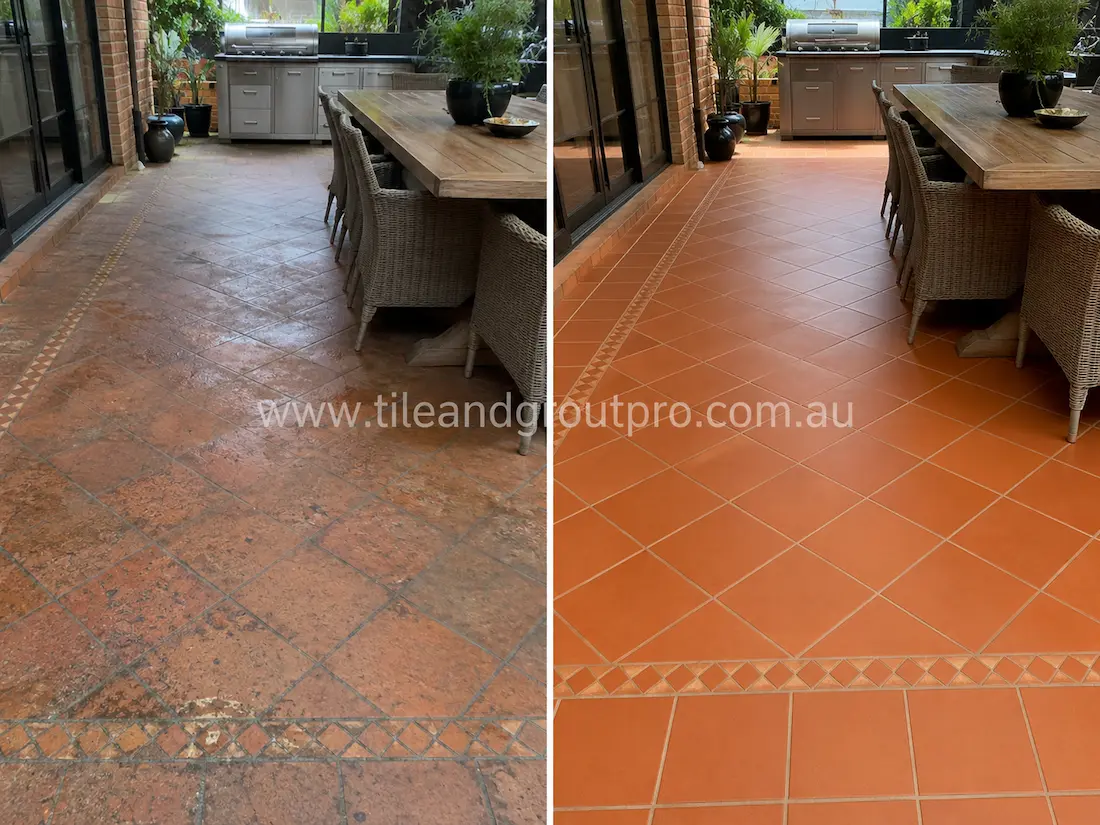 Before tile renewal, terracotta tiles in a covered outdoor entertaining area showed surface grime, faded finish, staining, and worn grout lines around the dining and barbecue zone.