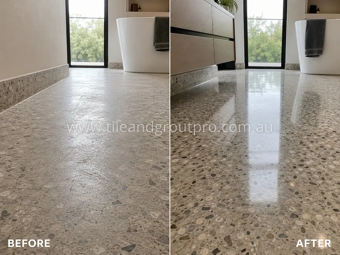Modern bathroom terrazzo floor before grinding, showing a dull stone surface with scratches and low shine near the freestanding bathtub and vanity.