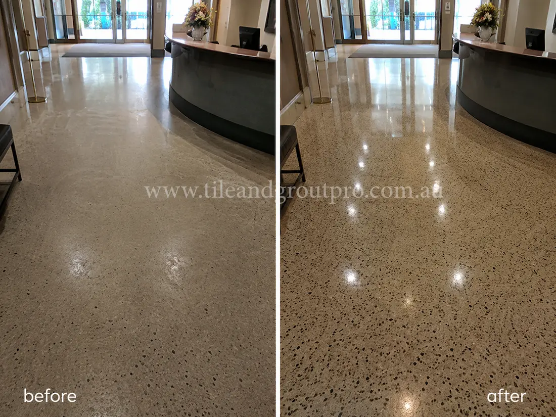Before tile renewal, the commercial terrazzo reception floor looked faded and matte with minimal reflection and signs of surface wear around the lobby desk.