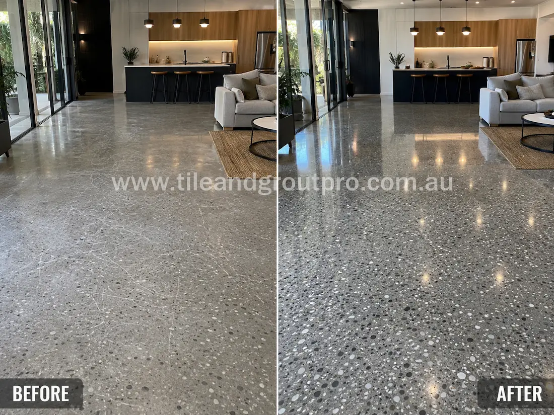 Open-plan living room terrazzo floor before grinding, displaying scratched aggregate flooring with a faded finish and low gloss in the modern residential interior.