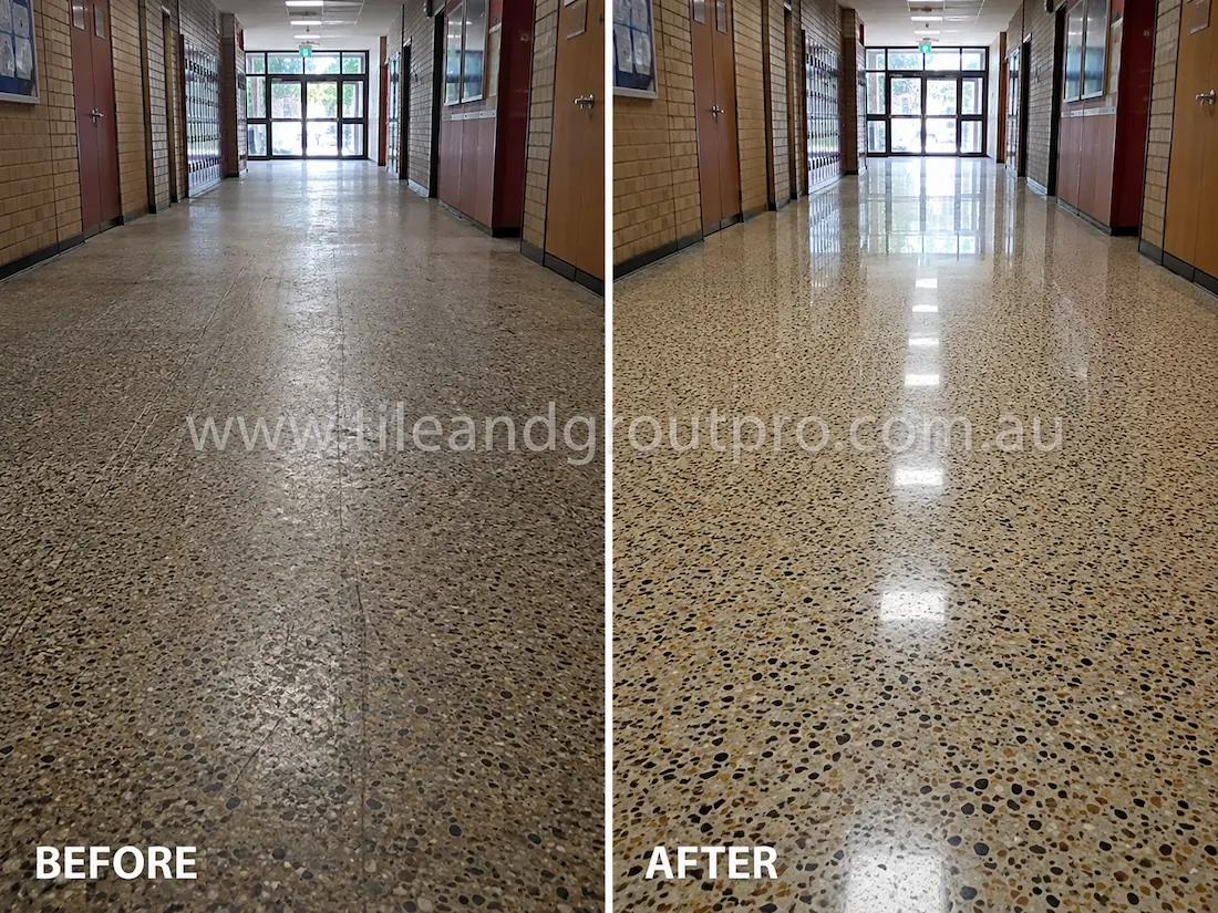 School hallway terrazzo floor before grinding, showing worn aggregate flooring with scratches, dull patches, and reduced reflectivity along the corridor lockers and classroom doors.