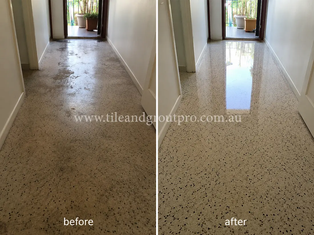 Before tile renewal, the terrazzo hallway floor showed dullness, patchy wear, and faded polishing in the residential corridor leading to the balcony doorway.