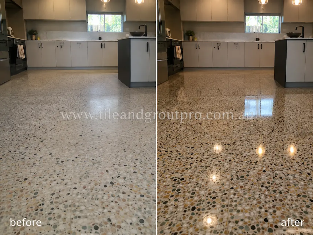 Before stone polishing, the terrazzo kitchen floor had a dull matte finish with muted stone aggregate detail and limited light reflection beneath modern cabinetry and pendant lighting.