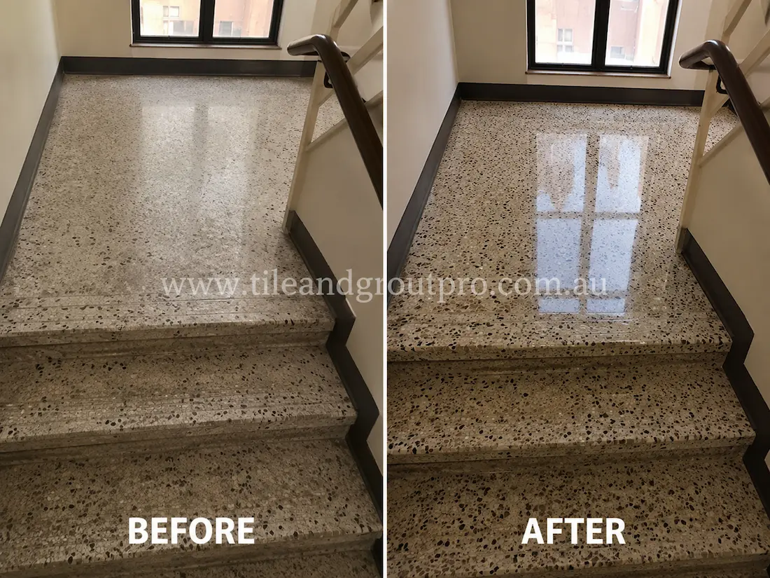 Before tile renewal, the terrazzo stair landing and steps had a dull surface finish with muted stone aggregate and minimal light reflection.