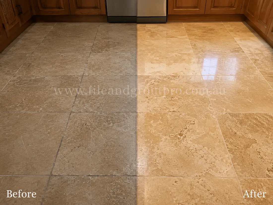 Travertine kitchen floor tiles beneath timber cabinetry showing traffic wear, scratches, and loss of sheen before professional tile resurfacing.