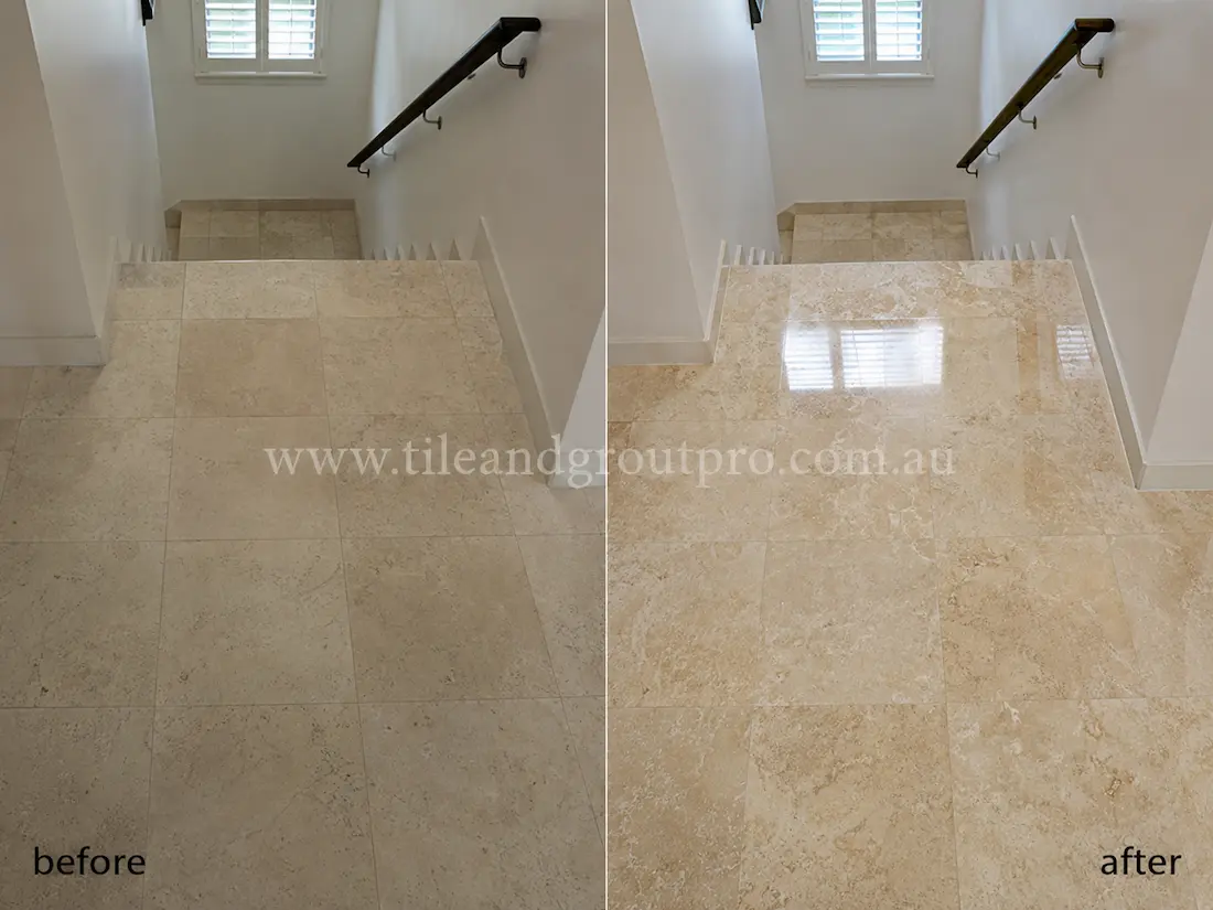 Before stone polishing, the cream travertine stair landing tiles looked flat and worn with minimal reflection in a residential staircase with white walls and dark timber handrails.