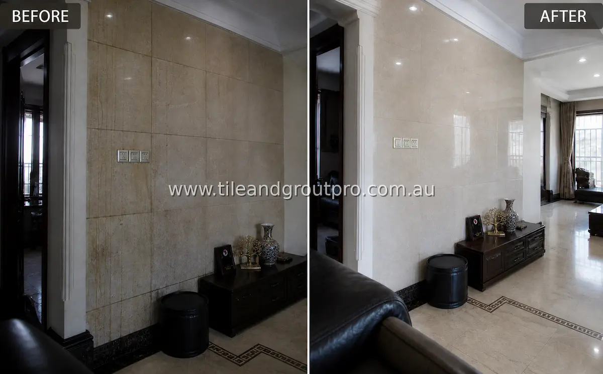 Living room partition wall with large-format ceramic tiles showing heavy dirt buildup, streaking, and dull discoloration before tile and grout cleaning
