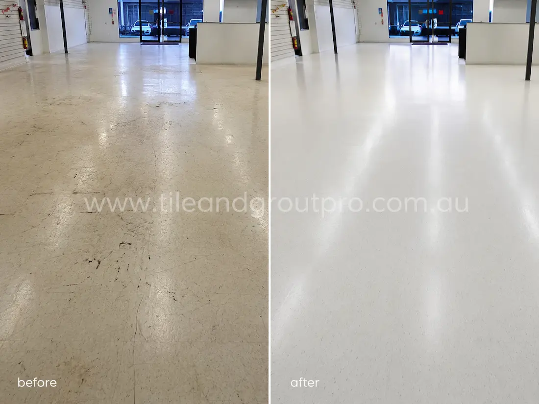 Large retail space with vinyl flooring before sealer stripping, showing scratched surfaces, worn sealer layers, and dull traffic marks across an open commercial interior.